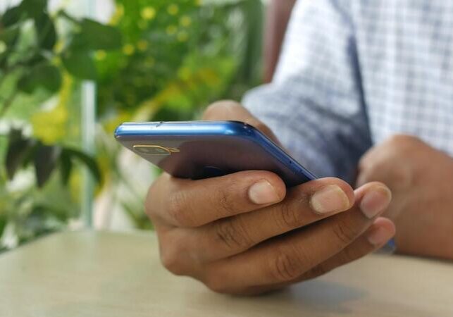 a-man-holding-a-blue-cell-phone-video